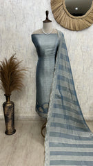 Mannequin wearing a blue saree with a striped pattern against a neutral wall.