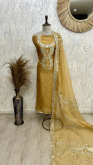Beige embroidered traditional outfit with dupatta on a mannequin against a neutral wall.