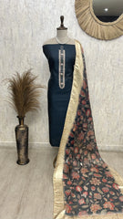 Mannequin wearing a navy blue dress with a floral dupatta against a neutral wall.