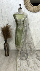 Green saree with silver embroidery on a mannequin against a white wall.